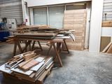 many pieces of wood sitting on a table in a room