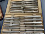 a lot of knives in a box on a table