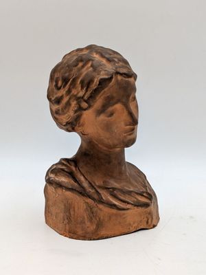bronze bust of a woman with a turban on her head