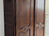 a large wooden cabinet in the corner of a room