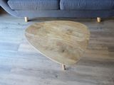 a wooden table with a heart shaped top on a wooden floor