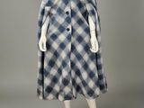 a blue and white checkered coat with buttons on a mannequin mannequin mannequin mann