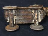 two wooden candlesticks sitting on top of a piece of wood