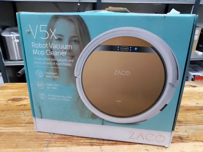 the box of the robot vacuum cleaner is open on the table