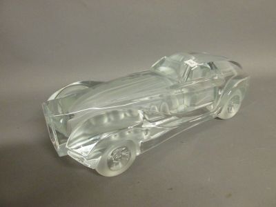 a clear plastic car that is sitting on a table