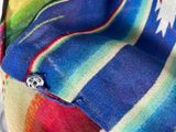 a multicolored blanket with a button on it