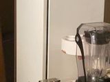 a blender sitting on top of a table next to a refrigerator
