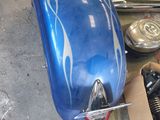a blue motorcycle parked in a garage next to other motorcycles