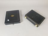pair of black and gold boxes on a white surface