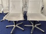 four chairs that are sitting in the middle of a blue carpet