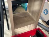 a red box filled with electronic equipment on the floor