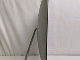 a computer monitor sitting on a stand on a table