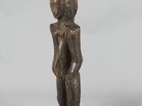 an old wooden statue of a man with a hat on his head