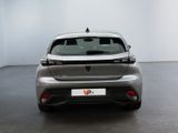 the rear end of a silver car in a white room