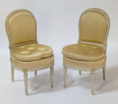 pair of chairs with upholstered seats and padded seat cushions