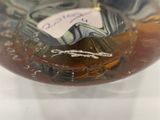 a close up of a glass bowl with a liquid inside of it