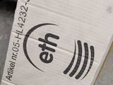 a cardboard box with a logo on it sitting on the ground