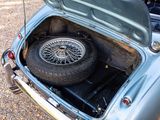 a car that has a tire in the trunk of it