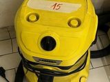 a yellow blow dryer sitting on the floor in a bathroom