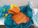 a plastic bag filled with clothes and other items on a table