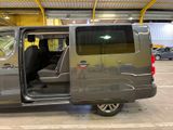 a silver van with its doors open in a parking lot