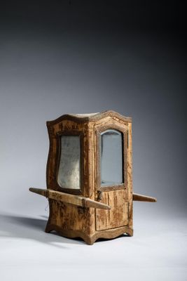 a small wooden cabinet with a mirror on it