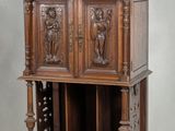 an old wooden cabinet with carvings on the top of it
