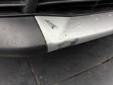 the front bumper of a car with water droplets on it