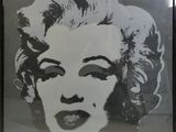 framed black and white photograph of a woman ' s face in a black frame