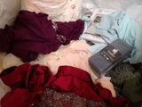 a lot of clothes that are laying on a bed