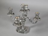 an image of a silver candelier with three candles on it