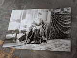 a black and white photo of a woman sitting in a chair