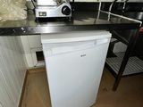 a white dishwasher sitting in a kitchen next to a sink