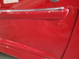 a close up of a red car door handle