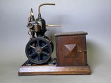 a small model of a steam engine on a wooden stand