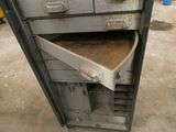 an old metal cabinet with a drawer inside of it