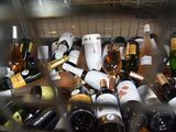 many bottles of wine sitting in a metal basket