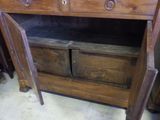 a wooden cabinet with two drawers and a door open
