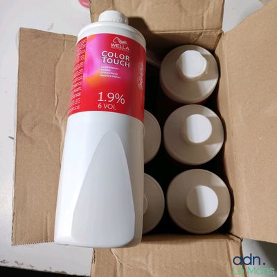 a bottle of liquid sitting inside of a cardboard box