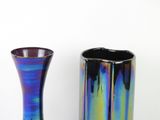two vases sitting next to each other on a table