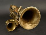 a brass instrument that is sitting on a black surface
