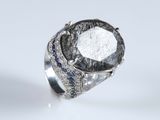 an image of a diamond and sapphire ring on a white surface