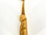 wooden figurine of a bear holding a ball on its back