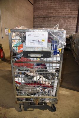 a metal cart with many items in it in a warehouse