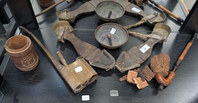 a lot of old tools on display in a glass case
