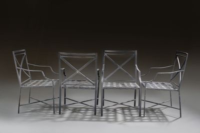 three chairs and a table on a white surface