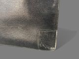 silver leather wallet with a pocket on a gray background