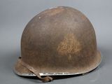 an old helmet is sitting on a table with a tag on it