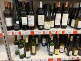 many bottles of wine on the shelves in the store