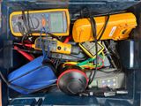 a blue box filled with electrical equipment and wires